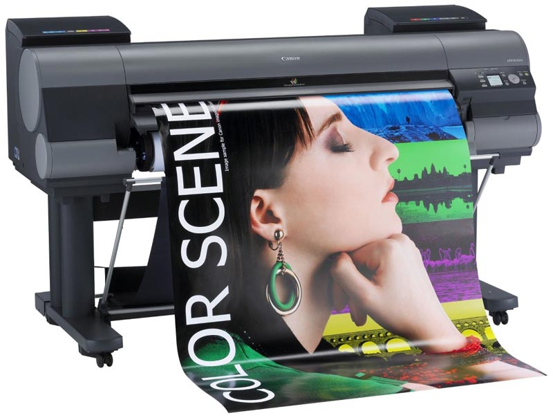 A large format printer prints a banner